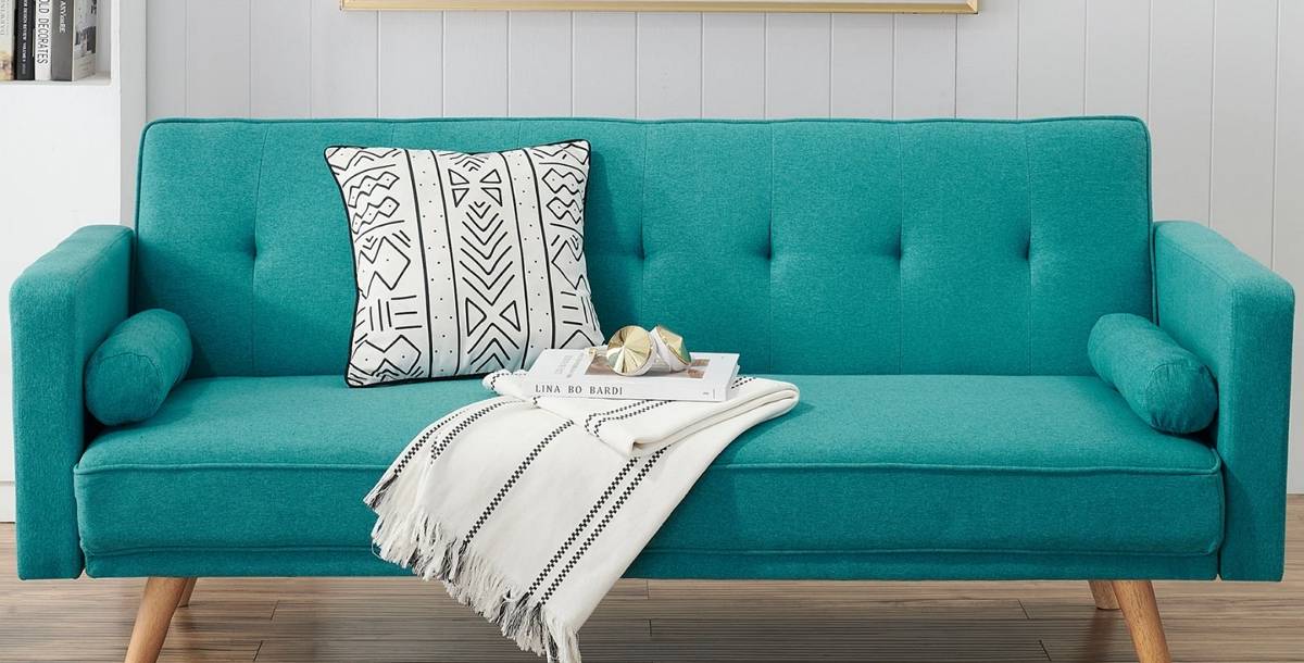 teal bolsters on a sofa along with the other decorative elements