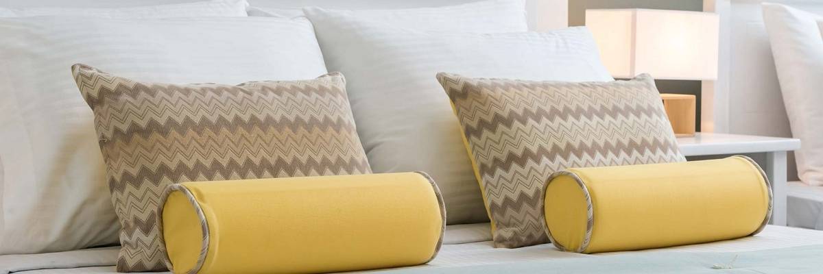 yellow bolster pillows in interior