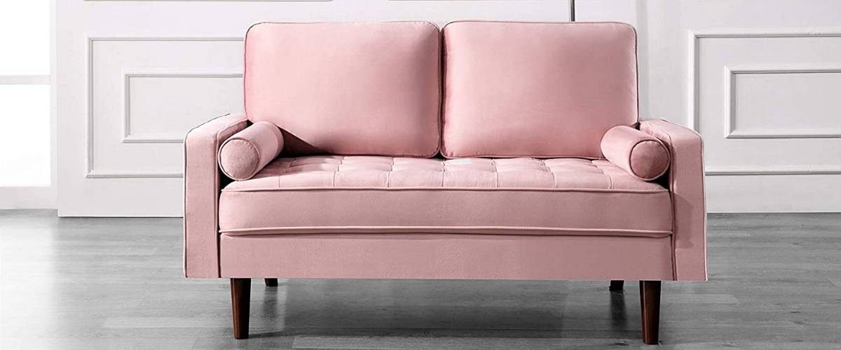 pink sofa with decorative bolster pillows