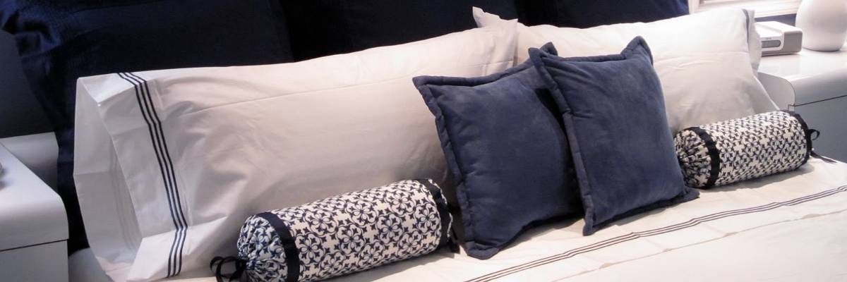 blue bolster pillows in a trendy interior