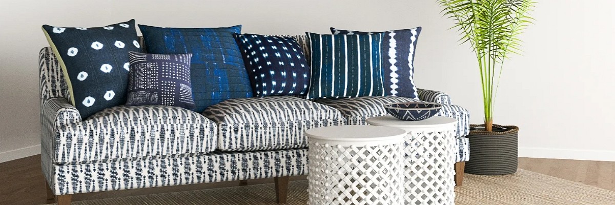 navy blue bolster pillows and square pillows in contrasting patterns