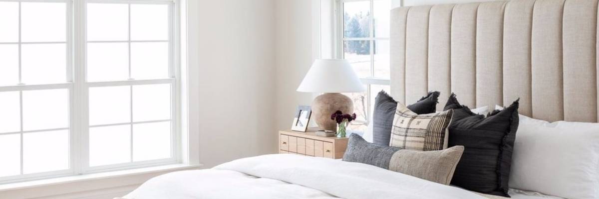 simple light interior with contrasting bolster pillows
