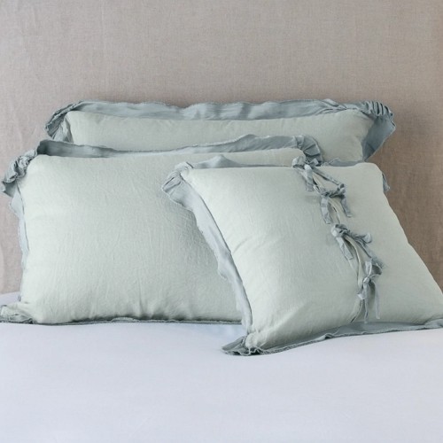 a set of pillows with light blue shams in light bohemian style
