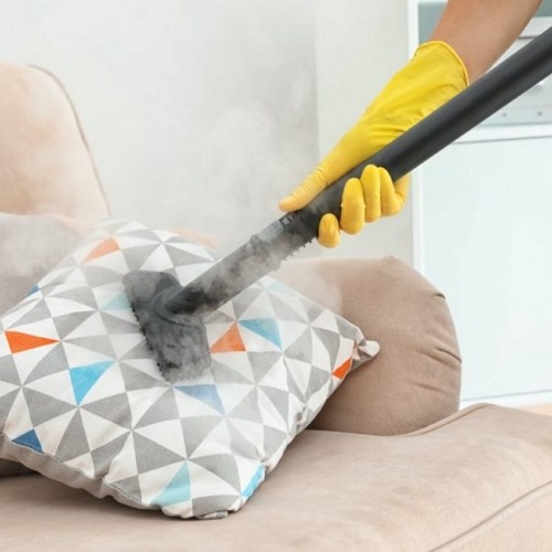 cleaning a throw pillow with a vacuum cleaner