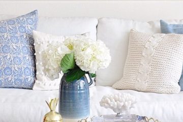 blue and beige bolster pillows in a classic simple interior