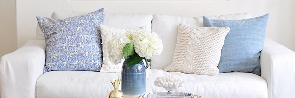 blue and beige bolster pillows in a classic simple interior