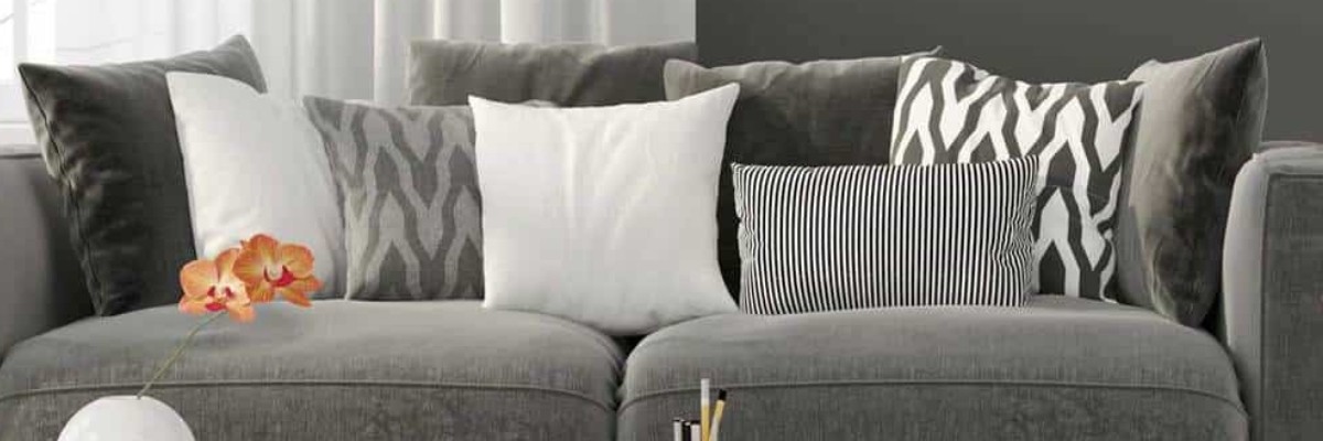 gray bolster pillows in a monochrome interior